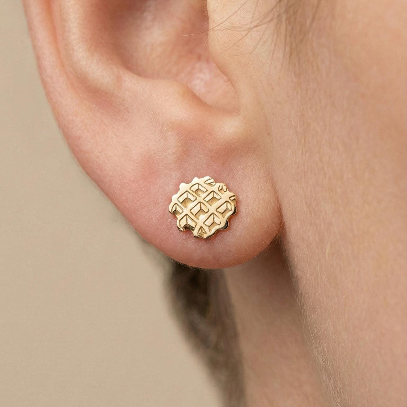Pair of small gold waffle stud earrings with a square grid texture, shown front on (2 of 7)