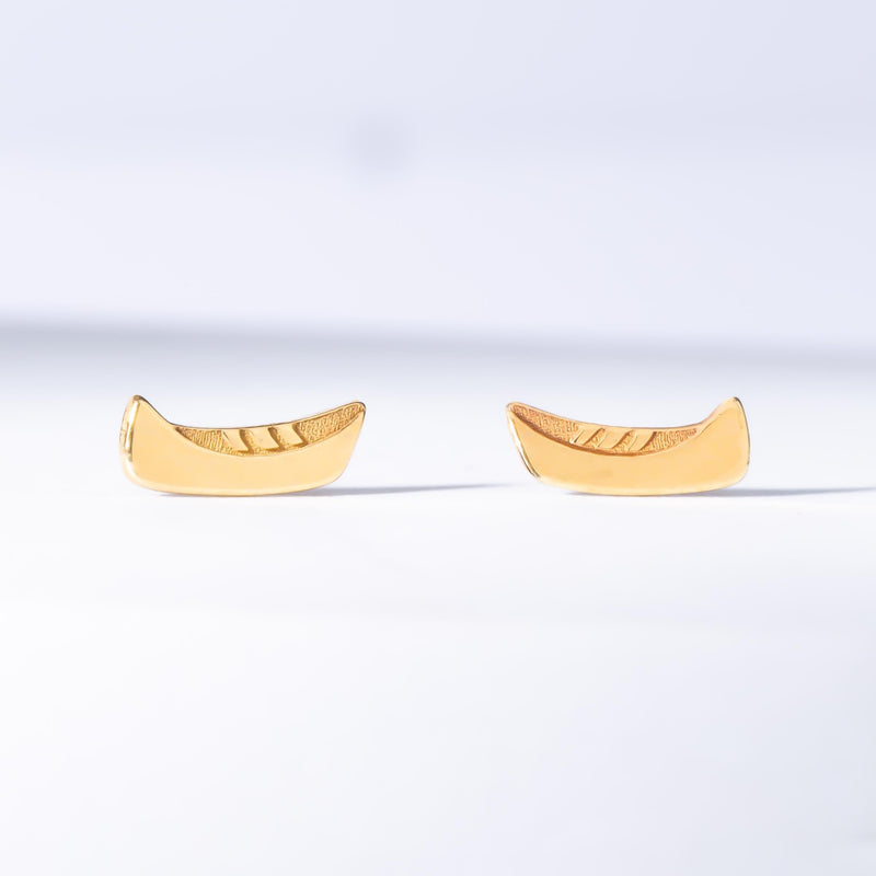 Dainty gold canoe pendant on a fine chain, shown from the side