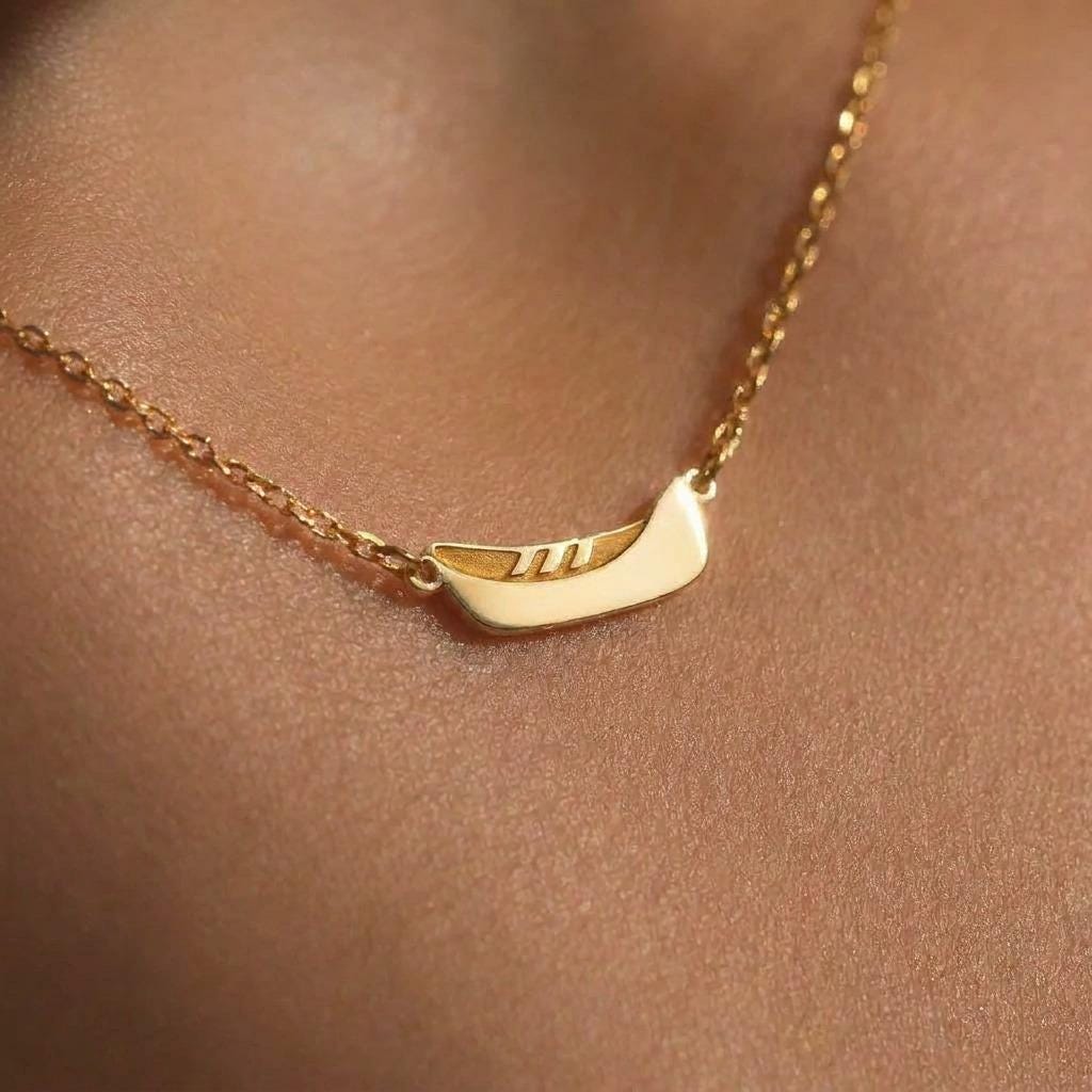 Dainty gold canoe pendant on a fine chain, shown from the side (2 of 12)