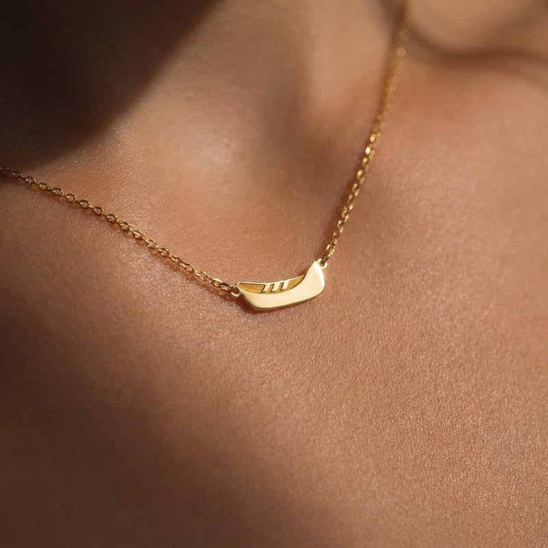 Dainty gold canoe pendant on a fine chain, shown from the side (3 of 12)