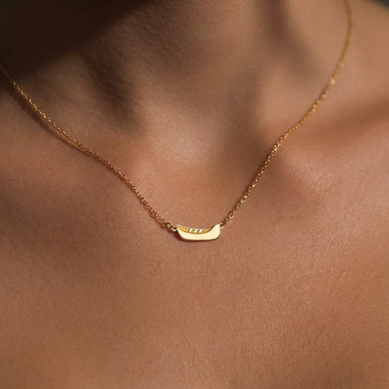 Dainty gold canoe pendant on a fine chain, shown from the side (4 of 12)