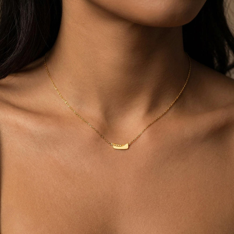 Dainty gold canoe pendant on a fine chain, shown from the side (5 of 12)