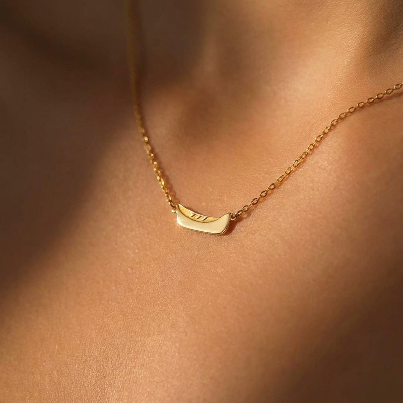 Dainty gold canoe pendant on a fine chain, shown from the side (8 of 12)