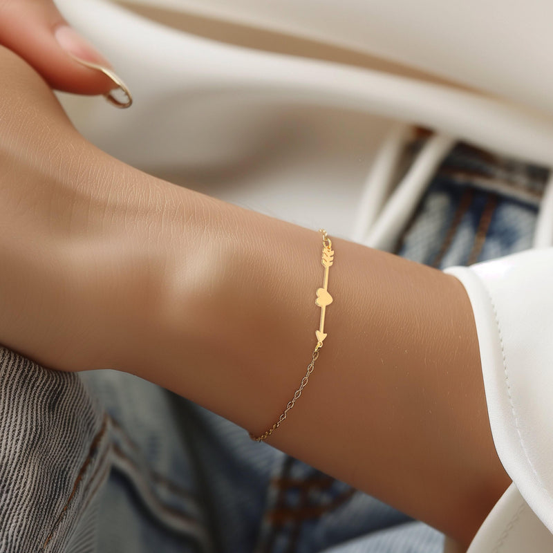 Fine gold chain bracelet with a flat heart and arrow charm (12 of 14)