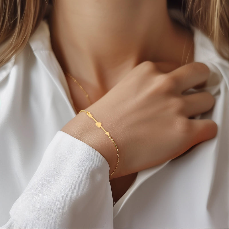 Fine gold chain bracelet with a flat heart and arrow charm (13 of 14)