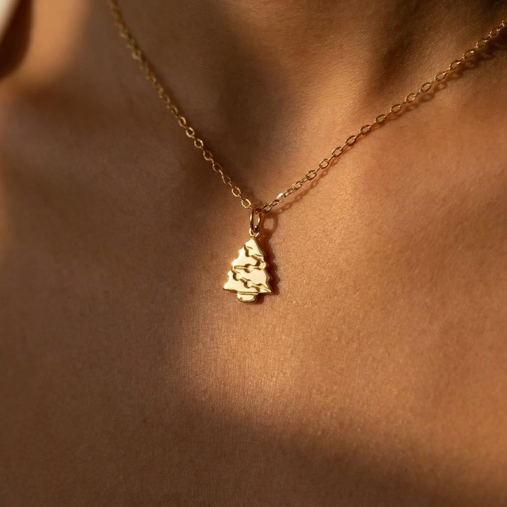Fine gold chain necklace with a small tiered Christmas tree pendant