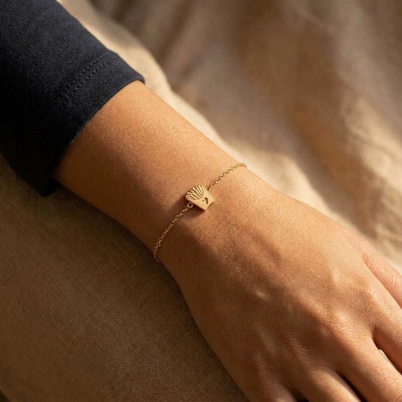 Fine gold chain bracelet with a tiny carton of french fries charm, on white (3 of 8)