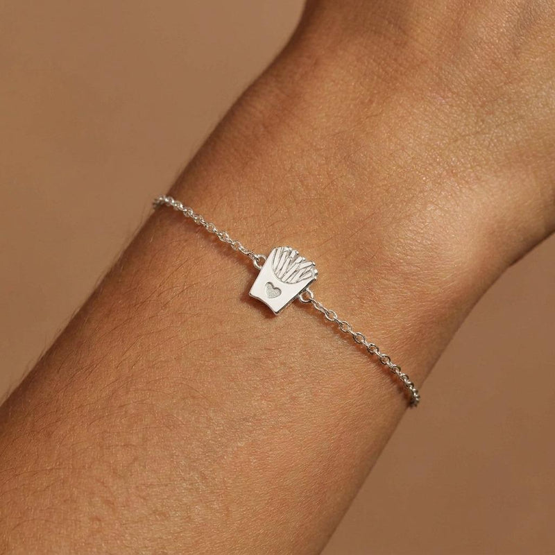 Fine gold chain bracelet with a tiny carton of french fries charm, on white (4 of 8)