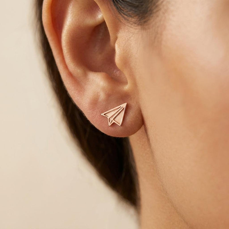 Tiny gold paper airplane stud earrings with cut fold lines, shown as a pair (3 of 7)