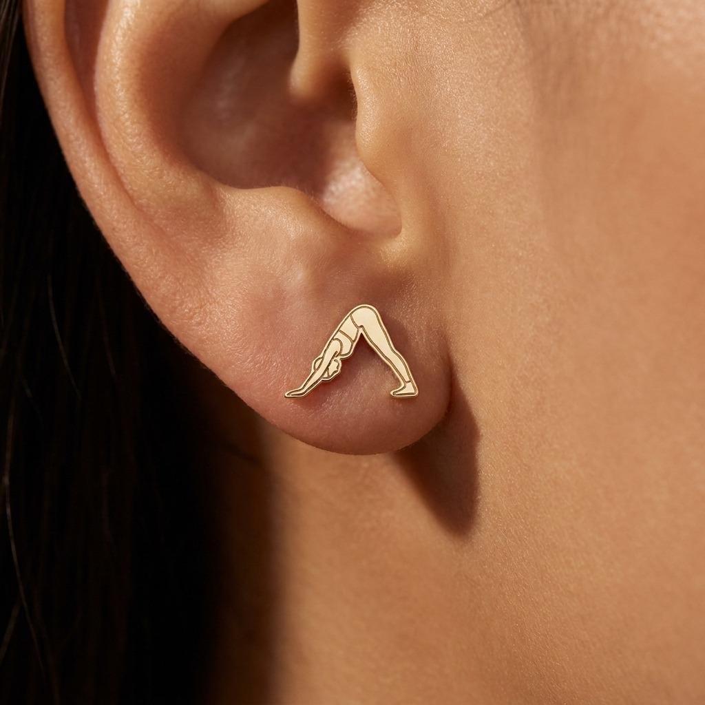 Pair of tiny gold stud earrings shaped like a figure in downward dog pose (2 of 9)