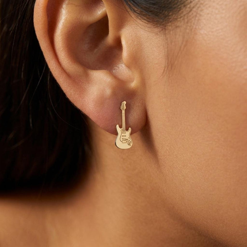 Pair of narrow gold electric guitar stud earrings shown upright. (3 of 9)