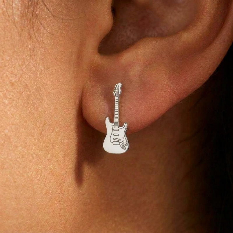 Pair of narrow gold electric guitar stud earrings shown upright. (5 of 9)
