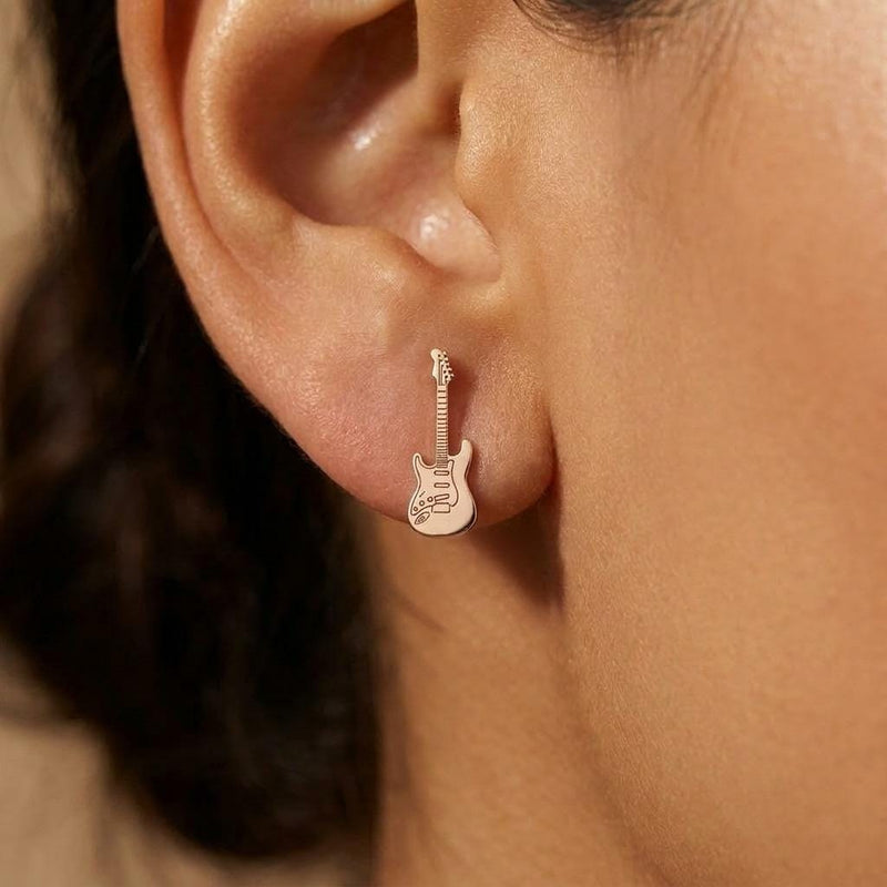 Pair of narrow gold electric guitar stud earrings shown upright. (6 of 9)