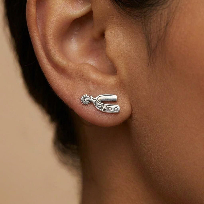 Pair of cowboy spur stud earrings in gold shown in profile with a rowel (7 of 10)