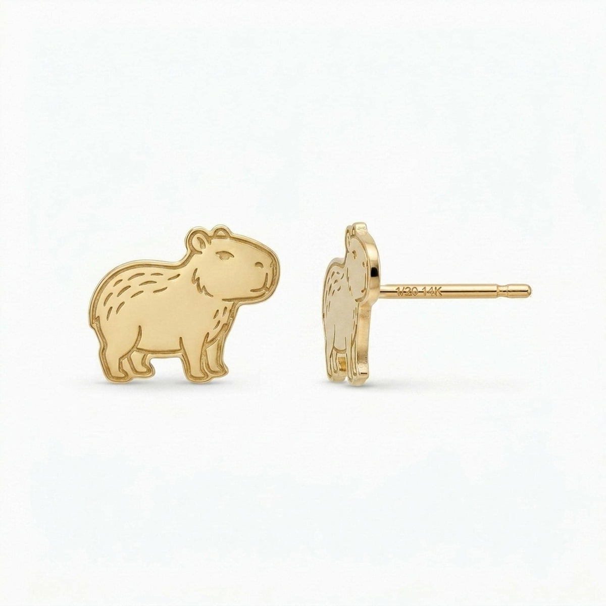 Pair of small gold capybara stud earrings shown sitting
