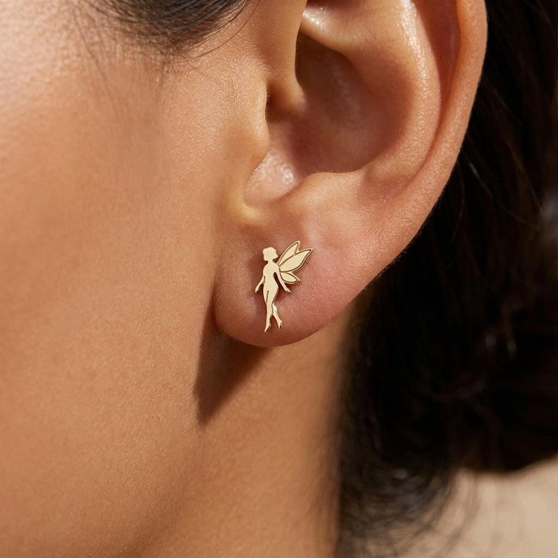 Pair of small gold fairy stud earrings with open wings behind the figure. (3 of 8)
