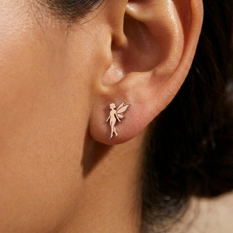 Pair of small gold fairy stud earrings with open wings behind the figure. (5 of 8)
