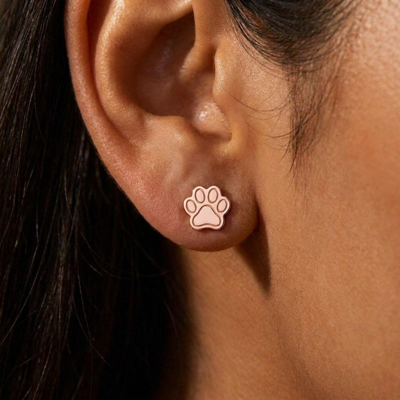 Pair of tiny gold paw print stud earrings with four toes and a rounded pad (5 of 10)