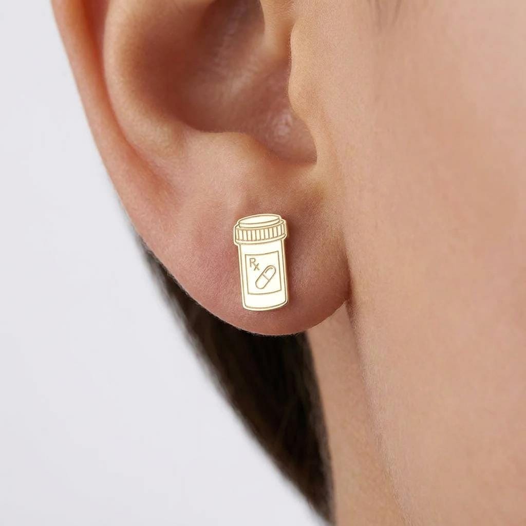 Small gold prescription pill bottle stud earrings with cap detail, shown as a pair (2 of 8)