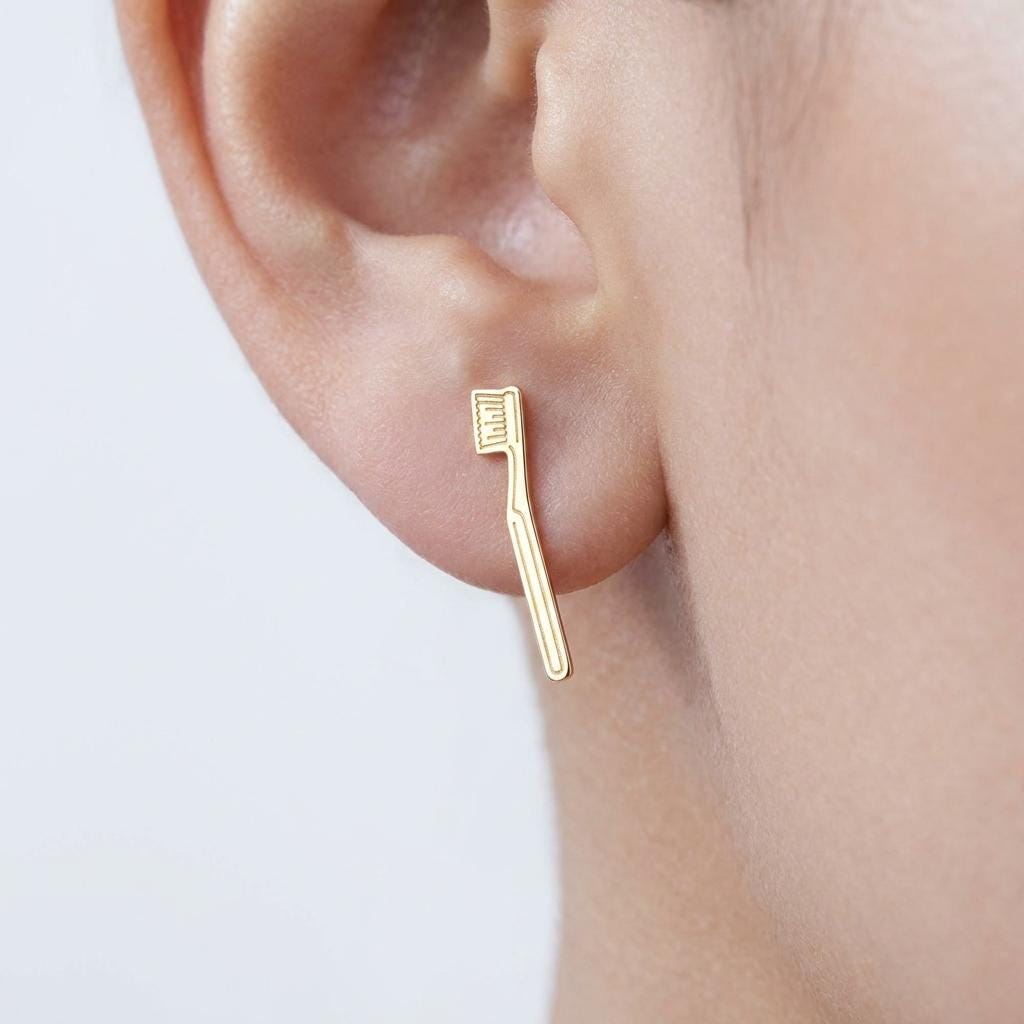 Pair of narrow gold toothbrush stud earrings with visible bristle detail (2 of 11)