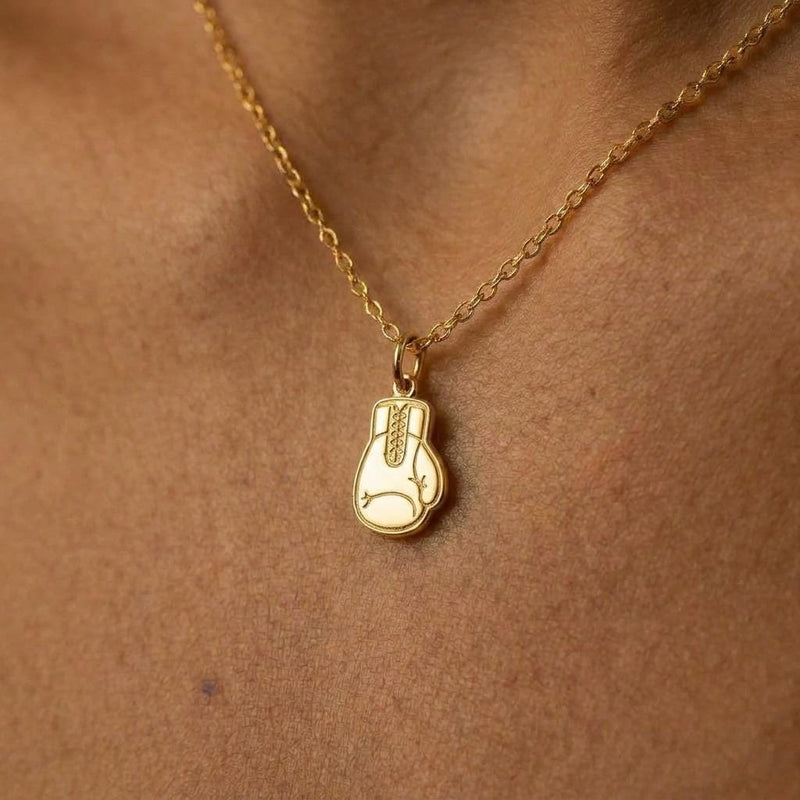 Gold boxing gloves charm necklace with two laced gloves on a fine cable chain