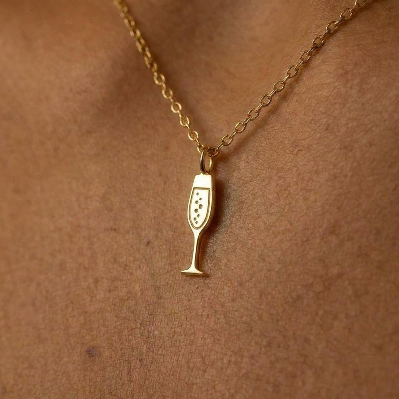 Dainty gold champagne flute charm necklace with bubbles, on a fine chain
