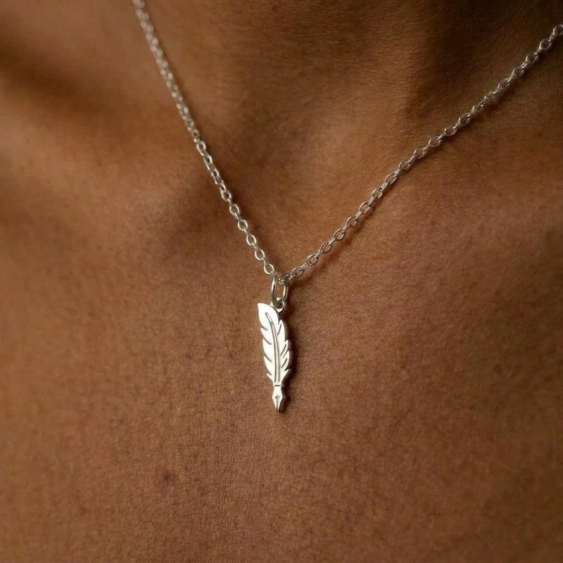 Long narrow gold feather quill pendant with scored barbs on a fine chain. (4 of 10)