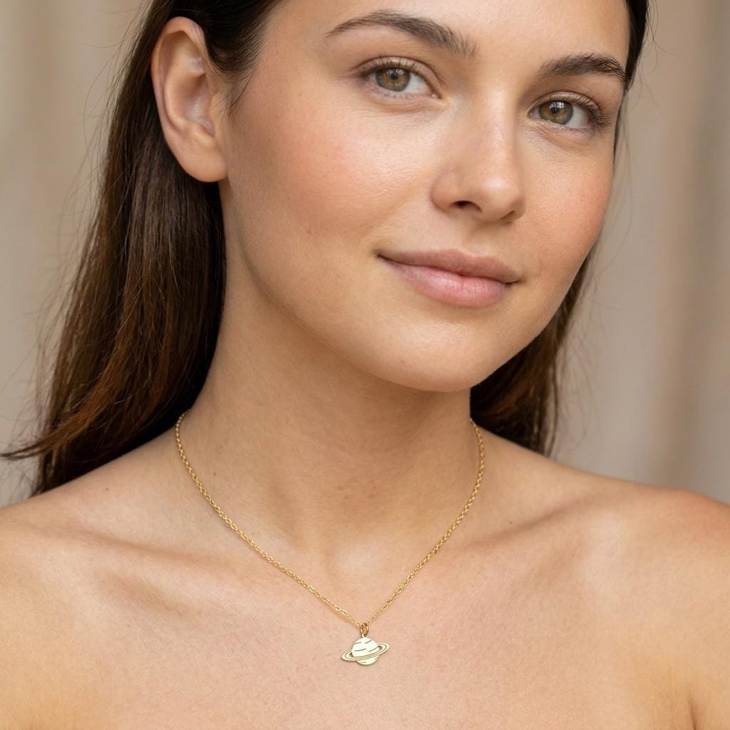 Dainty gold Saturn planet pendant with a ring, hanging from a fine cable chain (2 of 8)