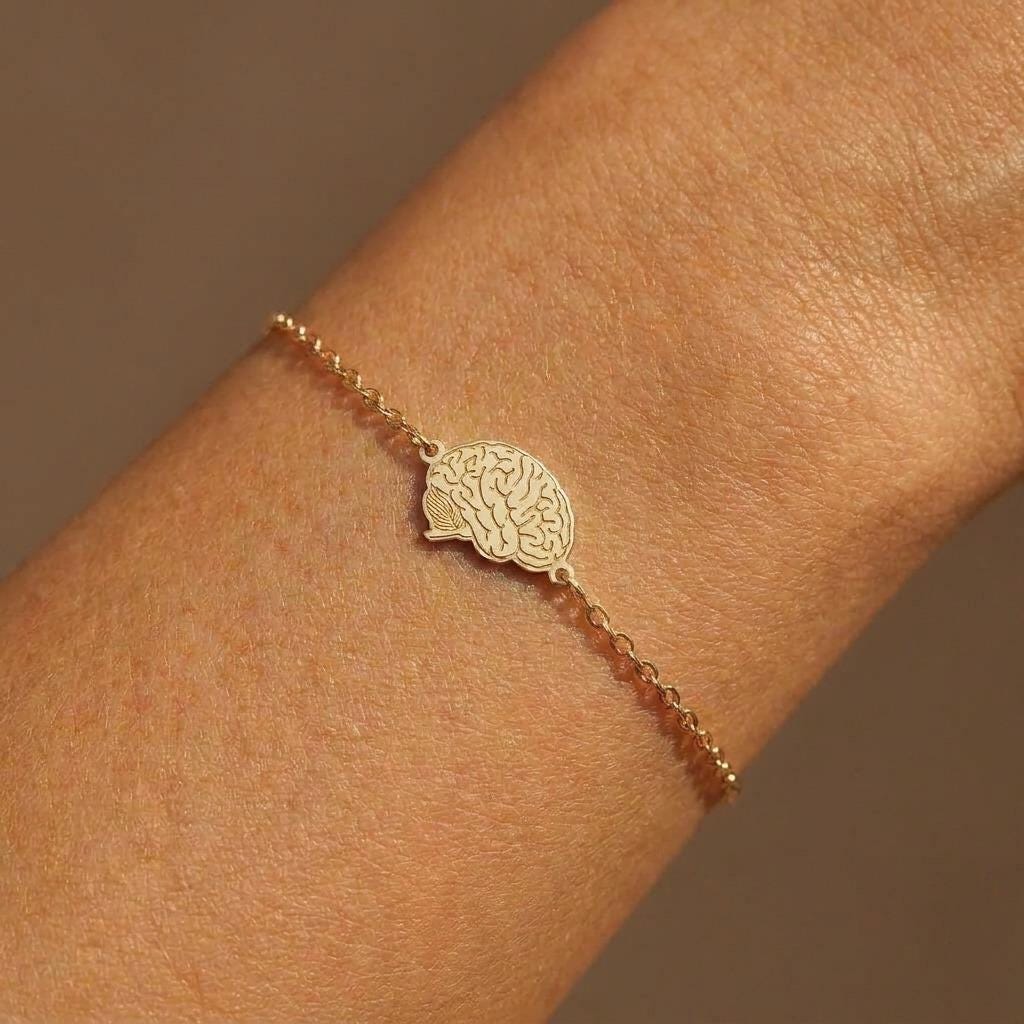 Small anatomical brain charm with detailed folds hanging from a fine chain bracelet (2 of 8)