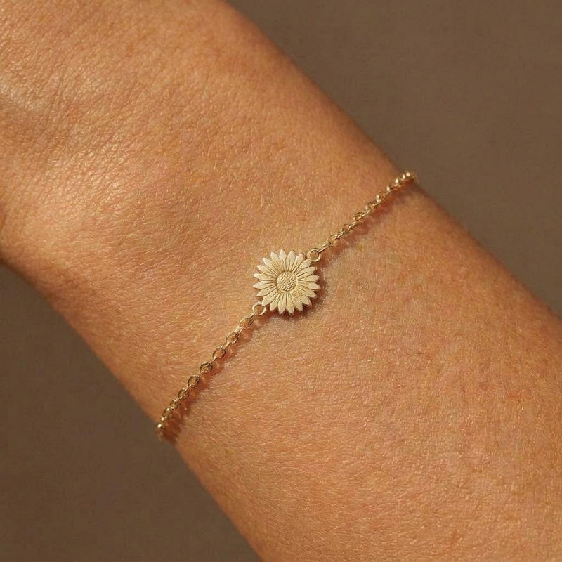 Fine gold chain bracelet with a small flat daisy flower charm (2 of 6)