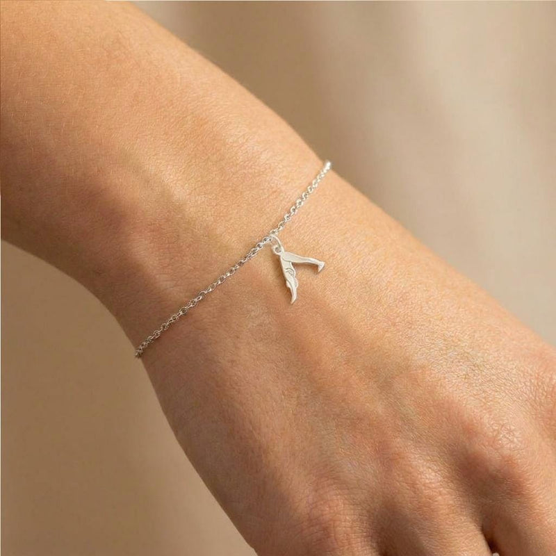 Fine gold chain bracelet with a small charm of a figure in downward dog pose (3 of 7)