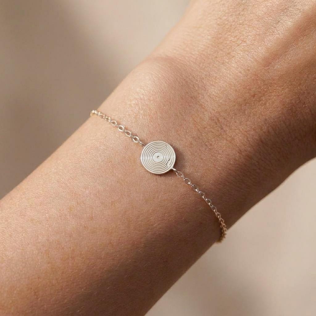 Tiny gold vinyl record charm with grooves and center label on a fine chain bracelet (2 of 6)