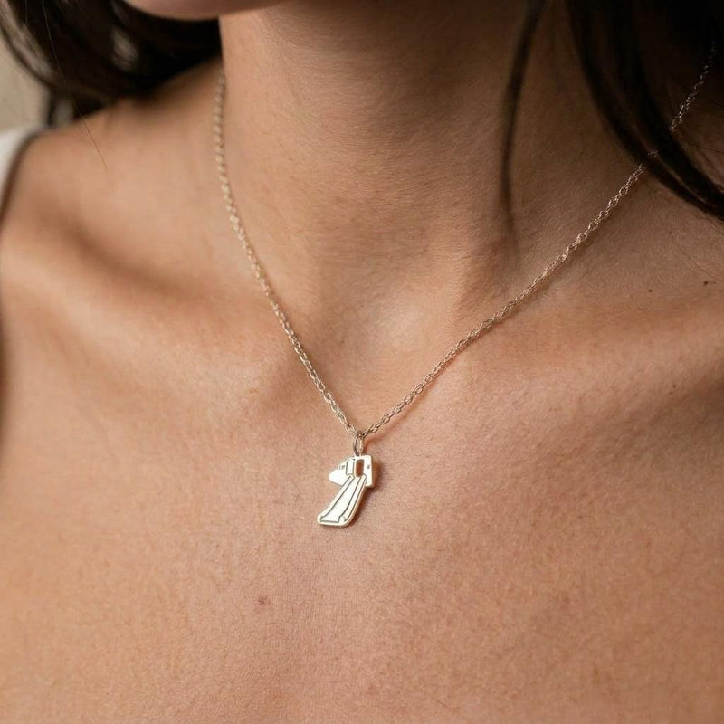 Gold pendant shaped like a deployed aircraft evacuation slide on a fine chain (3 of 8)