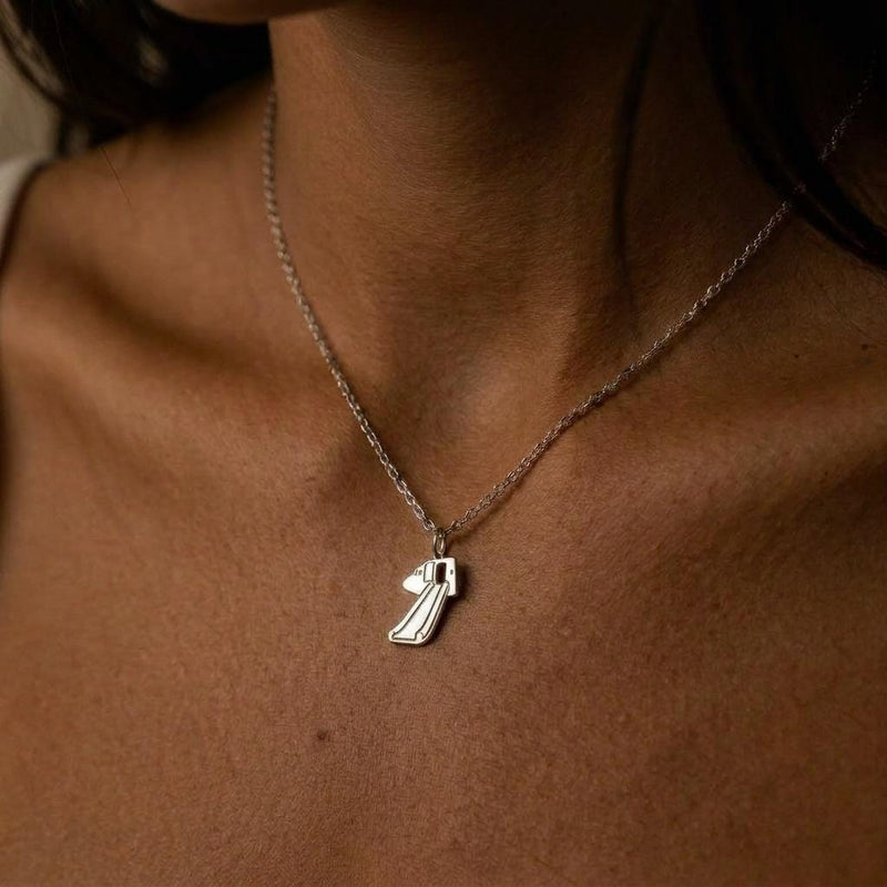 Gold pendant shaped like a deployed aircraft evacuation slide on a fine chain (4 of 8)