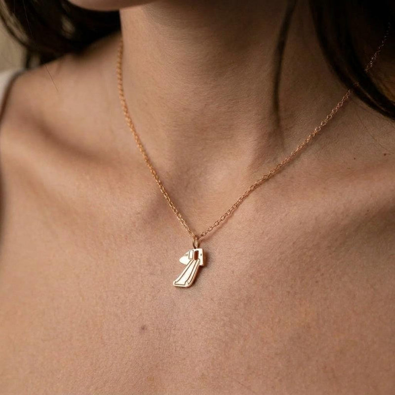 Gold pendant shaped like a deployed aircraft evacuation slide on a fine chain (5 of 8)