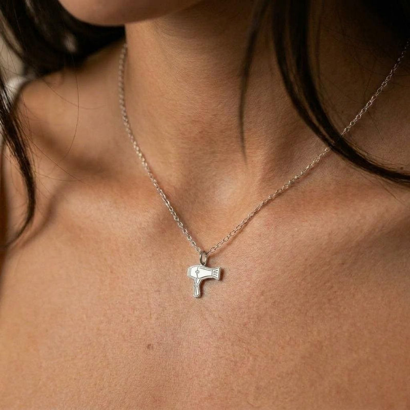 Small gold blow dryer charm necklace on a fine chain, nozzle and handle visible (2 of 9)