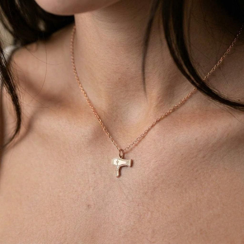 Small gold blow dryer charm necklace on a fine chain, nozzle and handle visible (5 of 9)