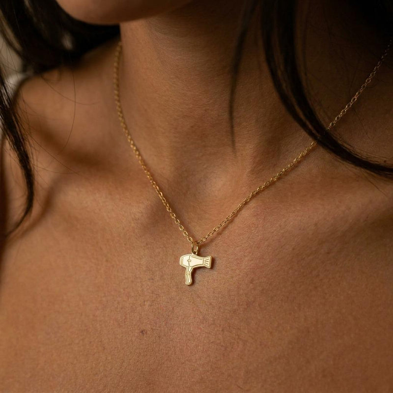 Small gold blow dryer charm necklace on a fine chain, nozzle and handle visible (6 of 9)