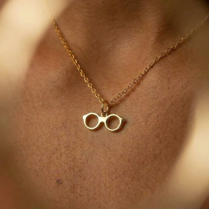 Fine gold chain necklace with a small round eyeglasses pendant