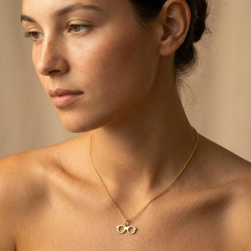Fine gold chain necklace with a small round eyeglasses pendant (2 of 9)