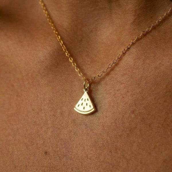 Small gold watermelon slice pendant with seed detail on a fine chain
