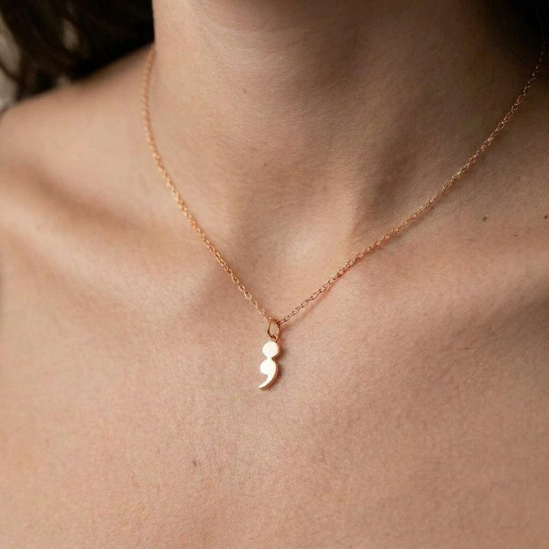 Fine gold chain necklace with a small semicolon shaped pendant (2 of 7)
