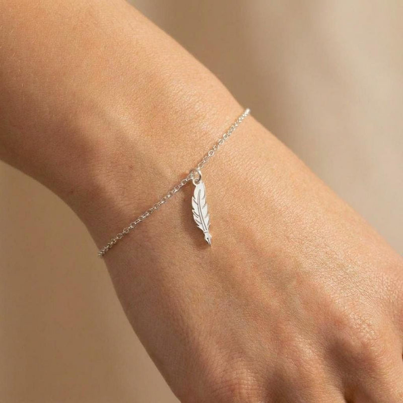 Fine gold chain bracelet with a small feather quill pen charm (2 of 6)