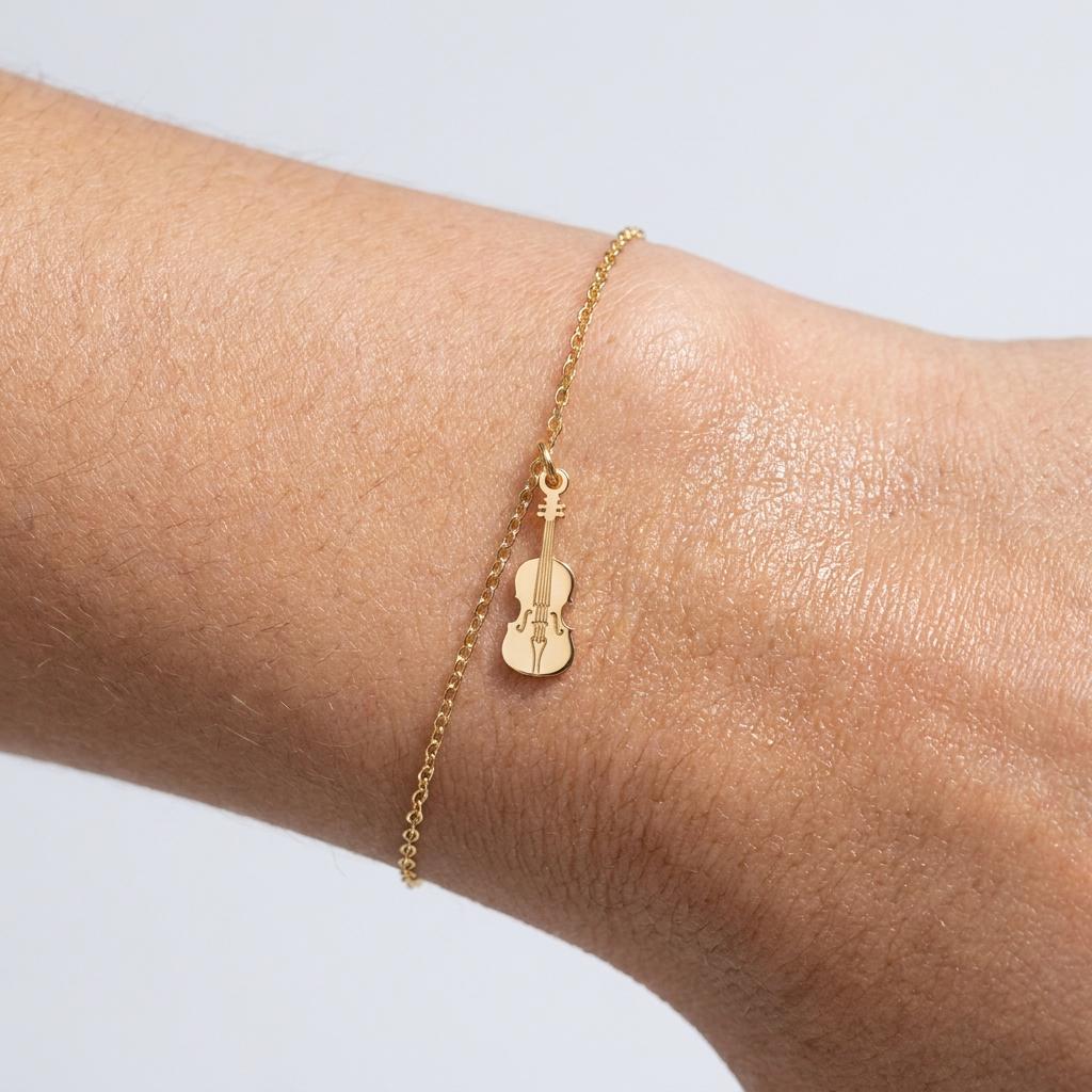 Fine gold chain bracelet with a small detailed violin charm (2 of 6)