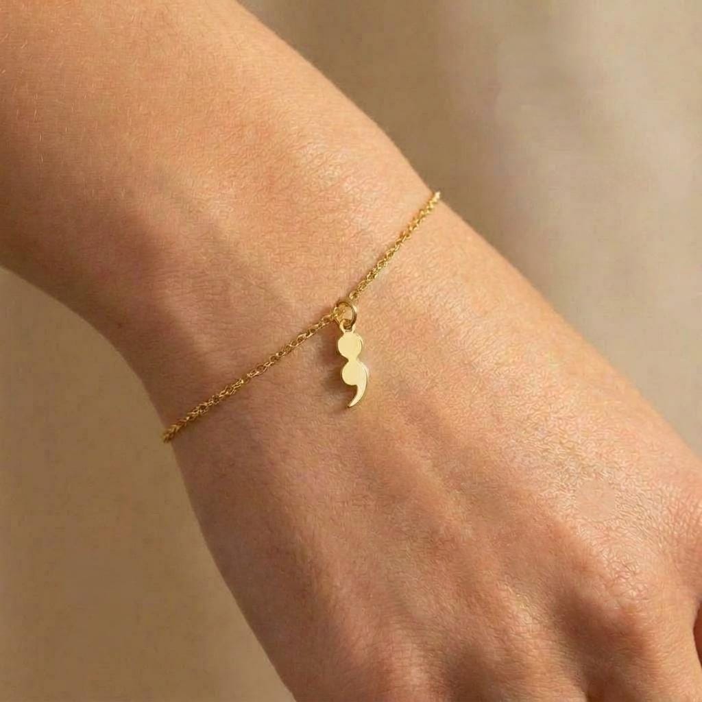 Fine gold chain bracelet with a small semicolon charm (2 of 7)