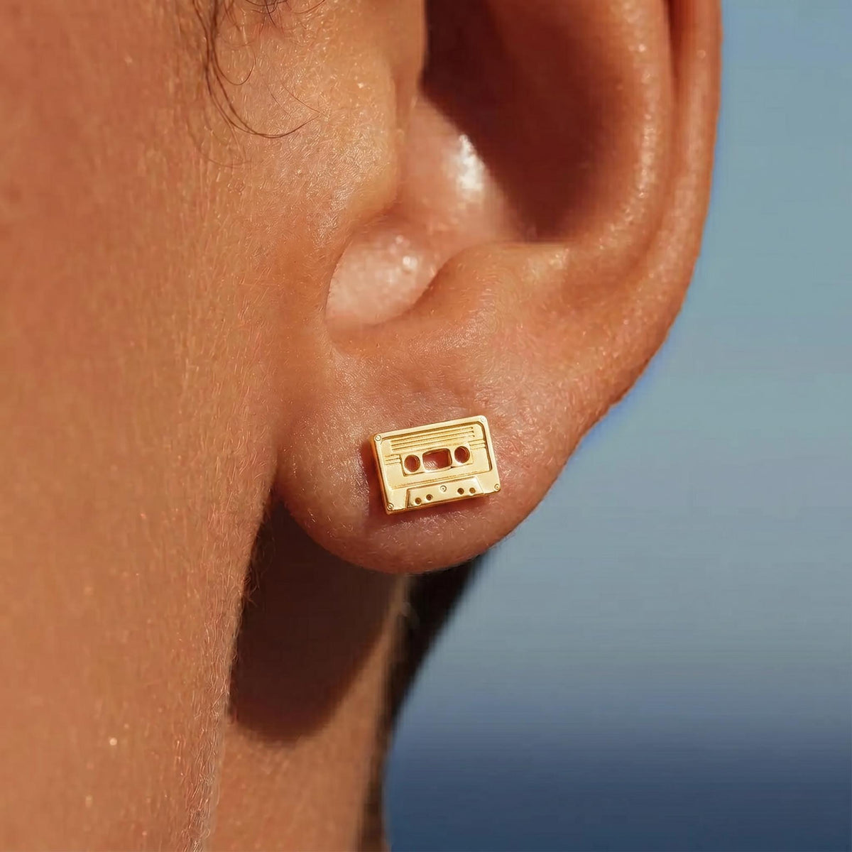 Pair of gold cassette tape stud earrings with reel detail