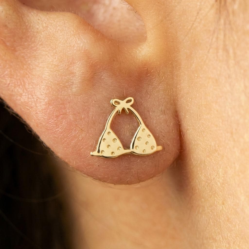 Pair of tiny bikini stud earrings in gold showing a two-piece swimsuit shape (2 of 6)