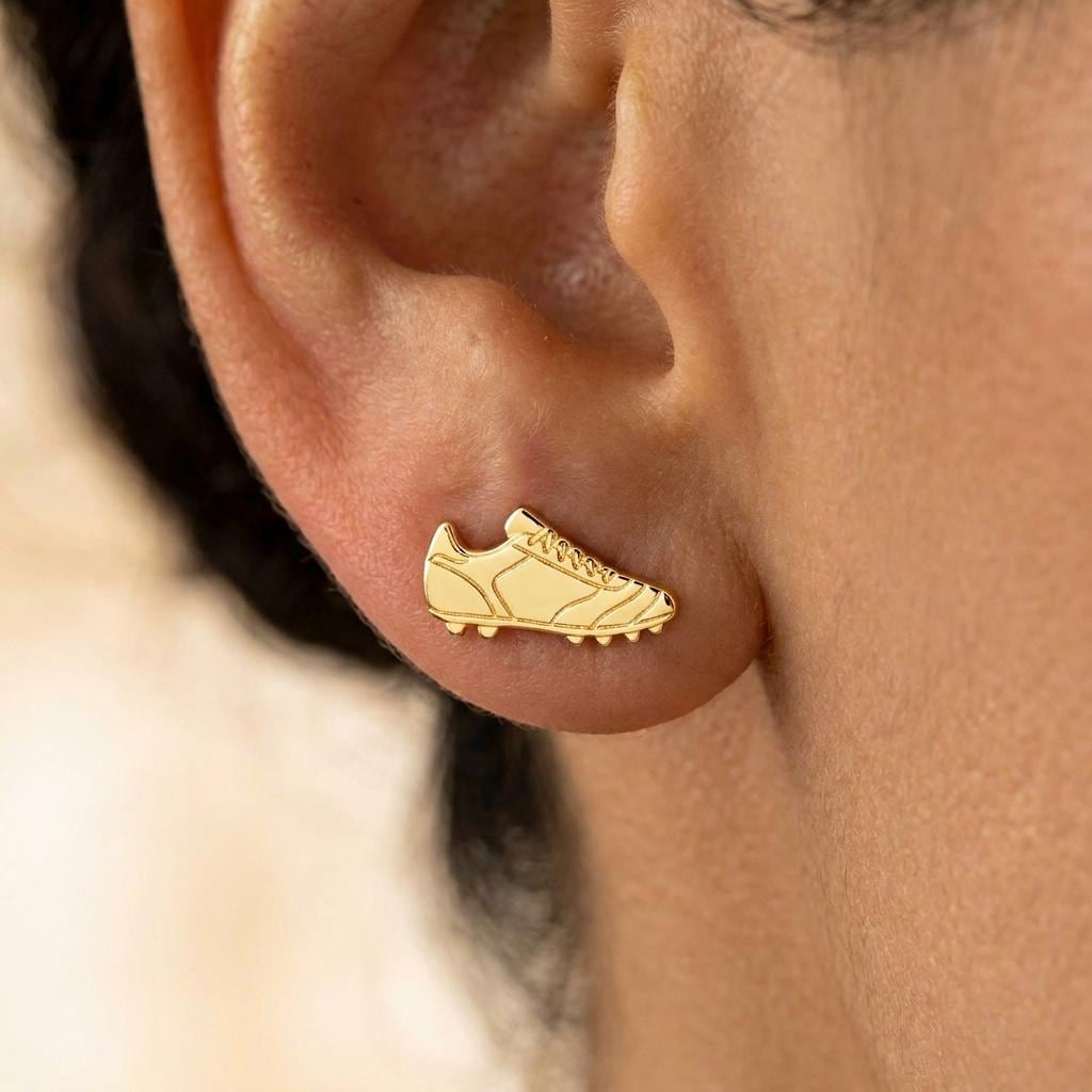 Pair of gold soccer cleat stud earrings shown in profile with lace detail (2 of 8)