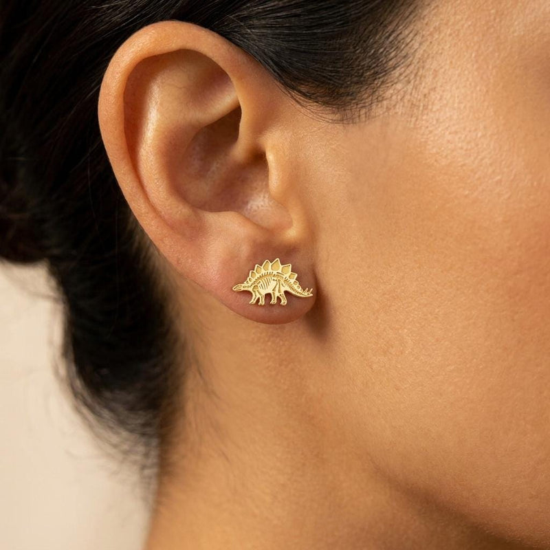 Pair of gold stegosaurus skeleton stud earrings showing back plates and tail spikes (3 of 6)