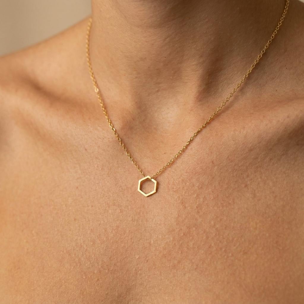 Small hexagon honeycomb pendant on a thin gold cable chain